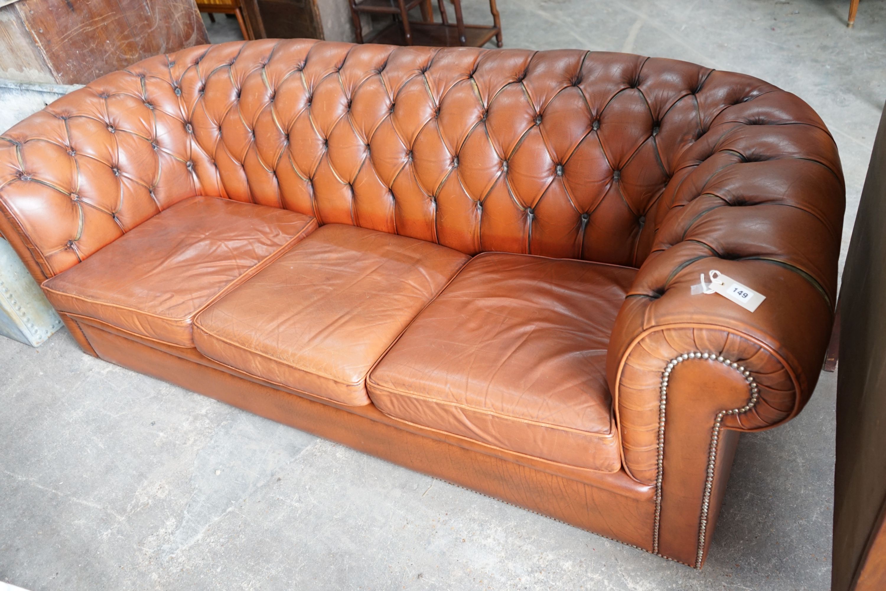 A modern Victorian style buttoned brown leather Chesterfield settee, length 200cm, depth 82cm, height 68cm